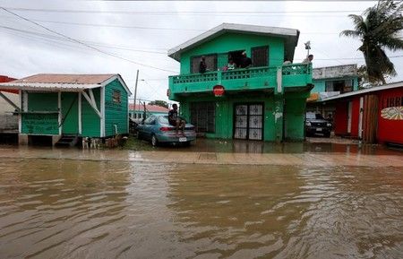 Local residents look on at flooded streets, after Hurricane Earl ...